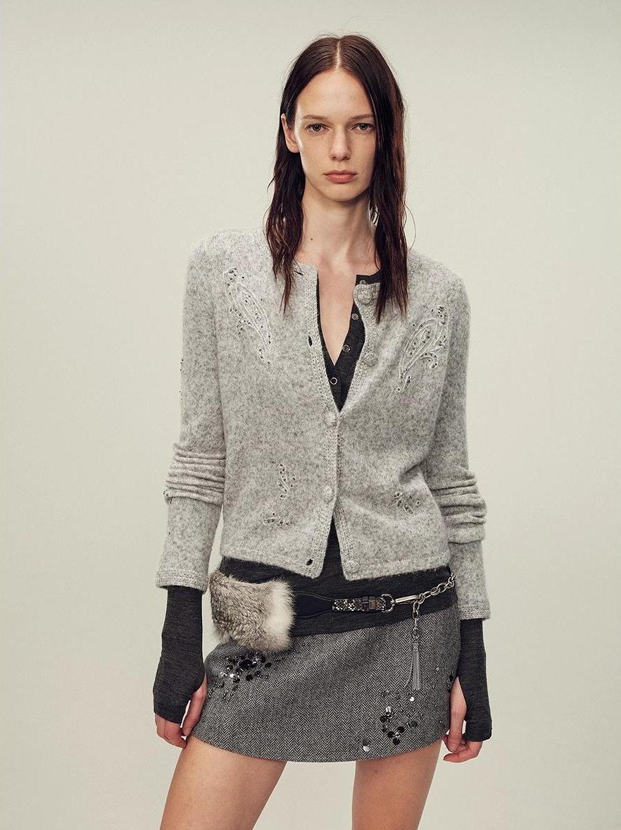 Heavy alpaca wool blend women's cardigan featuring hand-crocheted paisley embroidery and cloth-covered buttons.