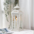 White and gold distressed 12-inch hexagon metal candle lantern with tempered glass panels