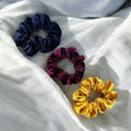 Plush velvet tranquil scrunchie hair tie infused with lavender, shown as a soft wrist accessory
