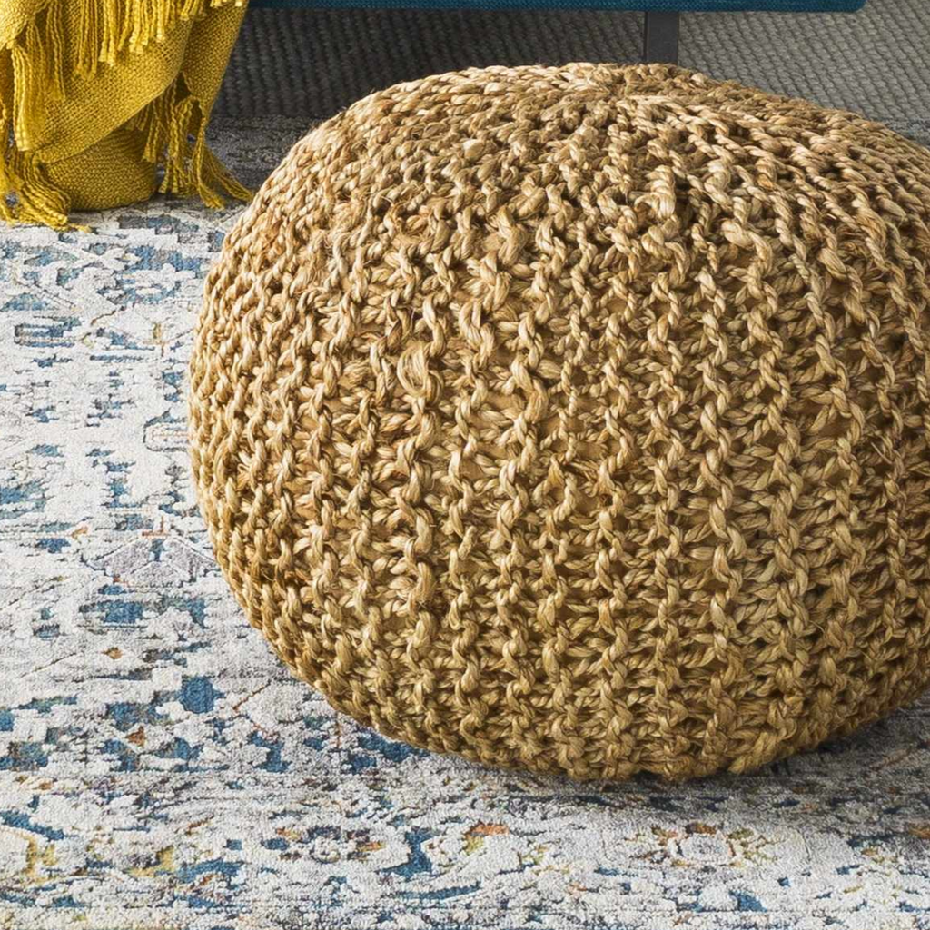 Round natural jute knitted pouf with textured surface, perfect for versatile floor seating and footrests