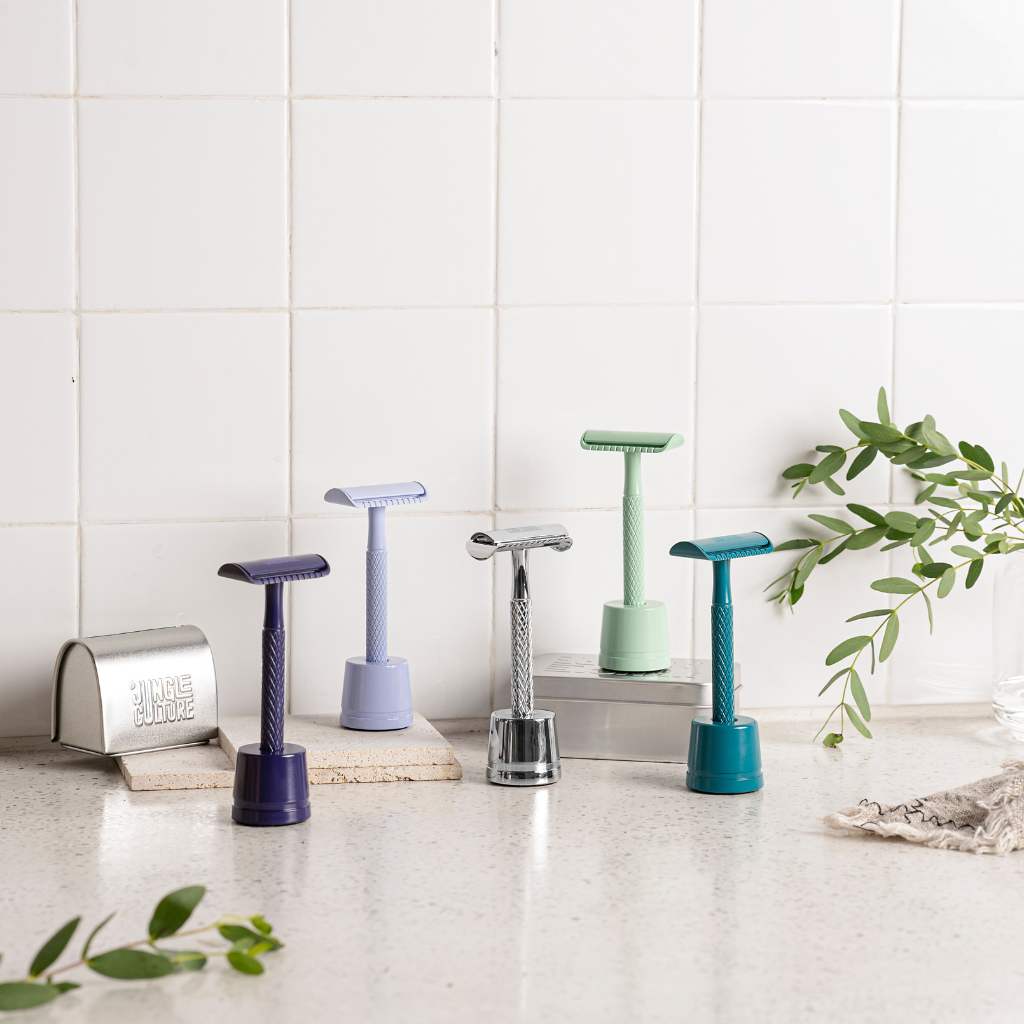 Textured diamond grip metal safety razor with ten replacement blades on a bathroom counter