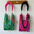 Whimsical pomponette knitted clutch bag in bright dopamine colors with a detachable shoulder strap