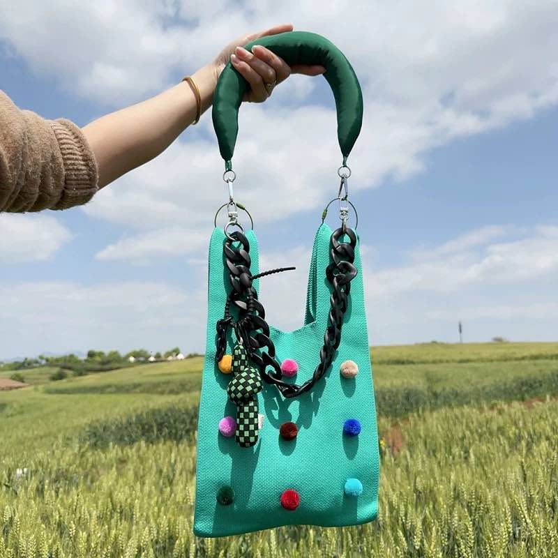 Whimsical pomponette knitted clutch bag in bright dopamine colors with a detachable shoulder strap — view 2