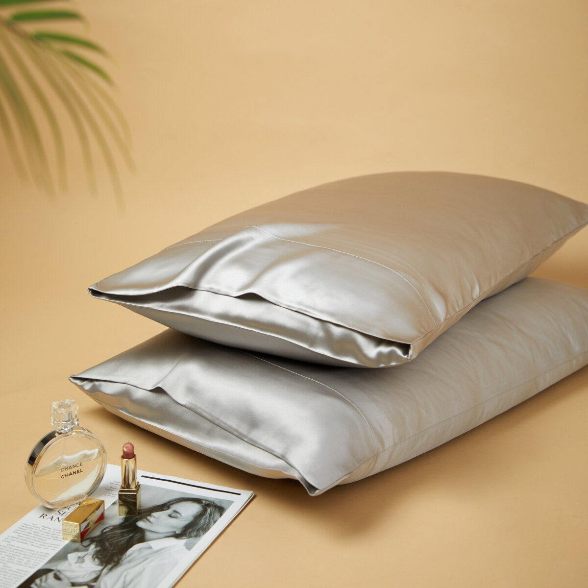 Premium mulberry silk reversible pillowcase duo folded neatly in a soft elegant bedroom setting — view 2