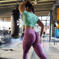 Plus size workout leggings in solid color featuring deep side pockets and a mid-rise fit