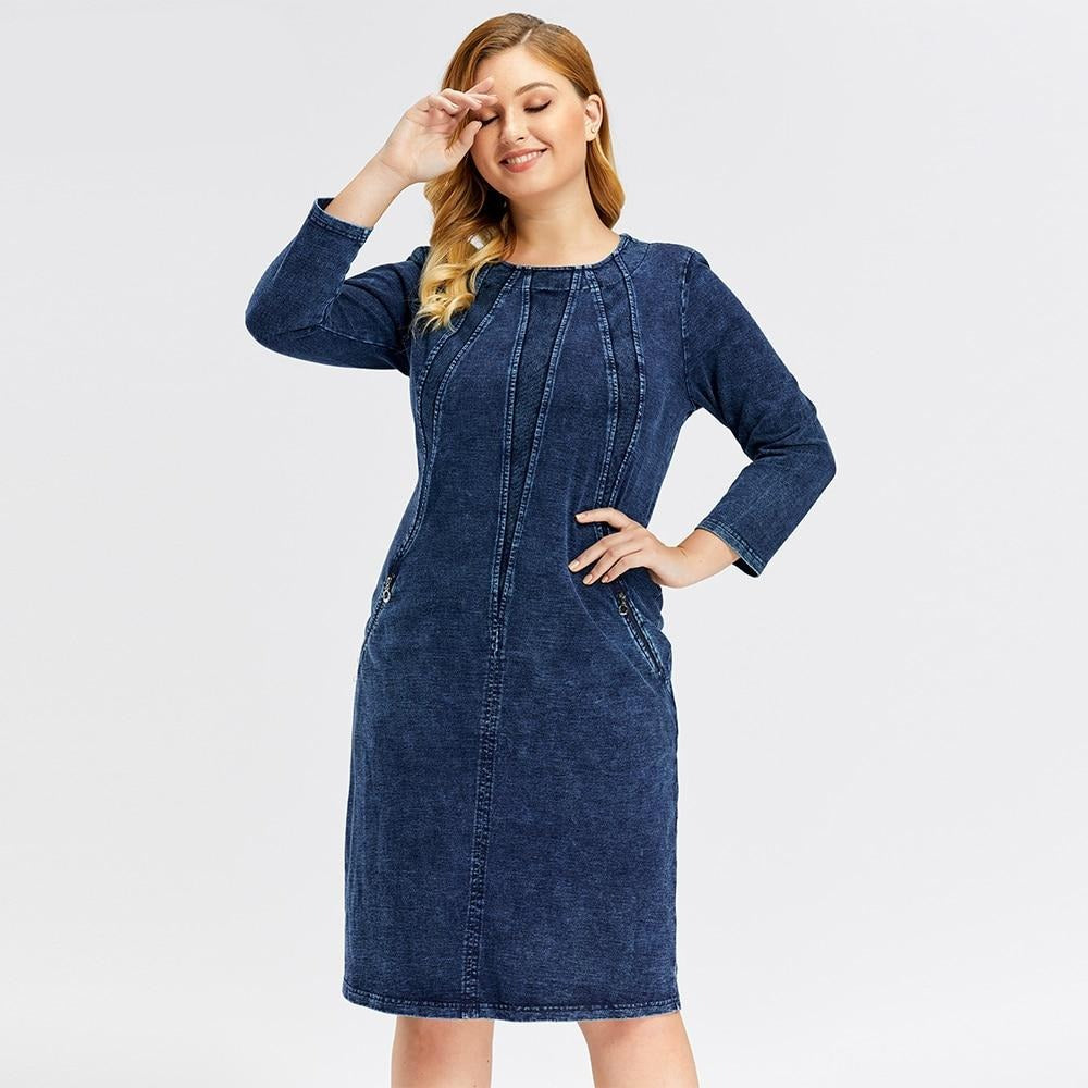 Plus size women's stretch denim sheath dress with three-quarter sleeves and shoulder pads.
