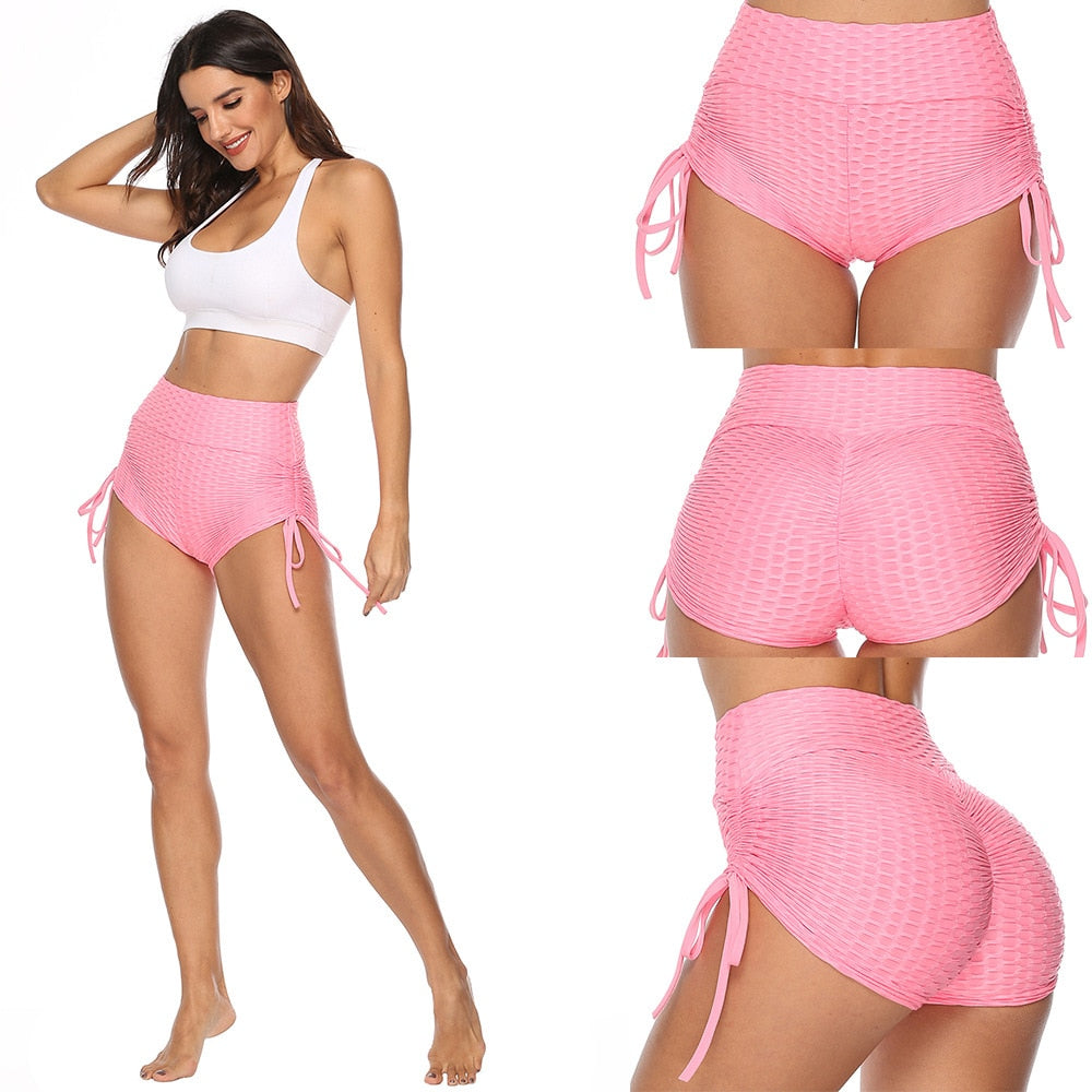 Women's black push-up workout shorts with elastic mid-waist and anti-cellulite textured fabric design