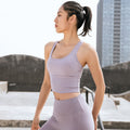 Seamless cross back sports bra in smooth nylon fabric with thin straps and push-up support