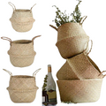 Handmade natural seagrass storage basket with sturdy handles functioning as a woven plant pot cover