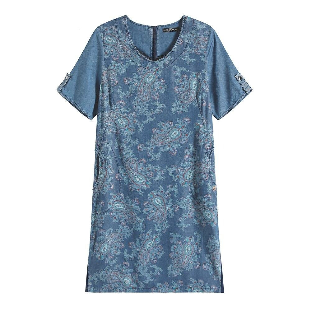 Plus size printed denim dress with V-neck, three-quarter sleeves, and front pockets.