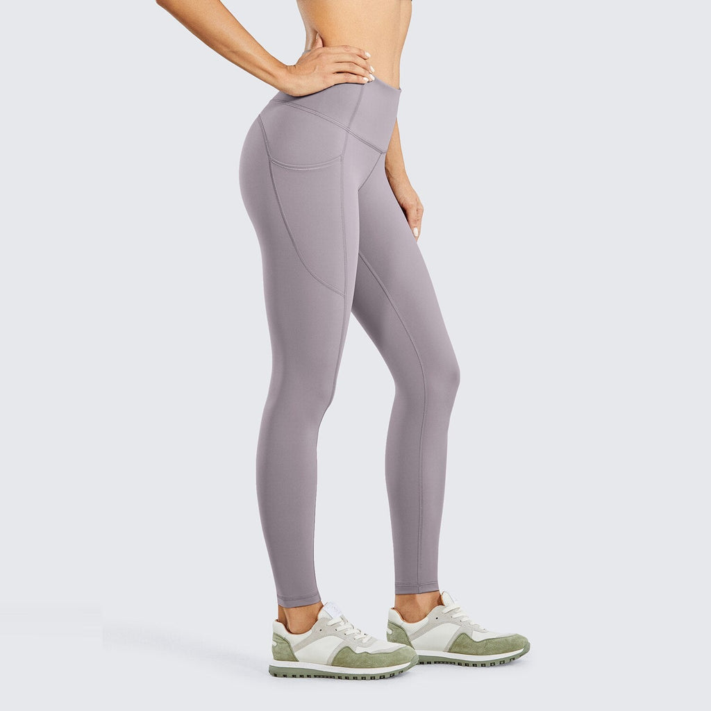 Women's compression training leggings with side pockets and high waist tummy control in solid color