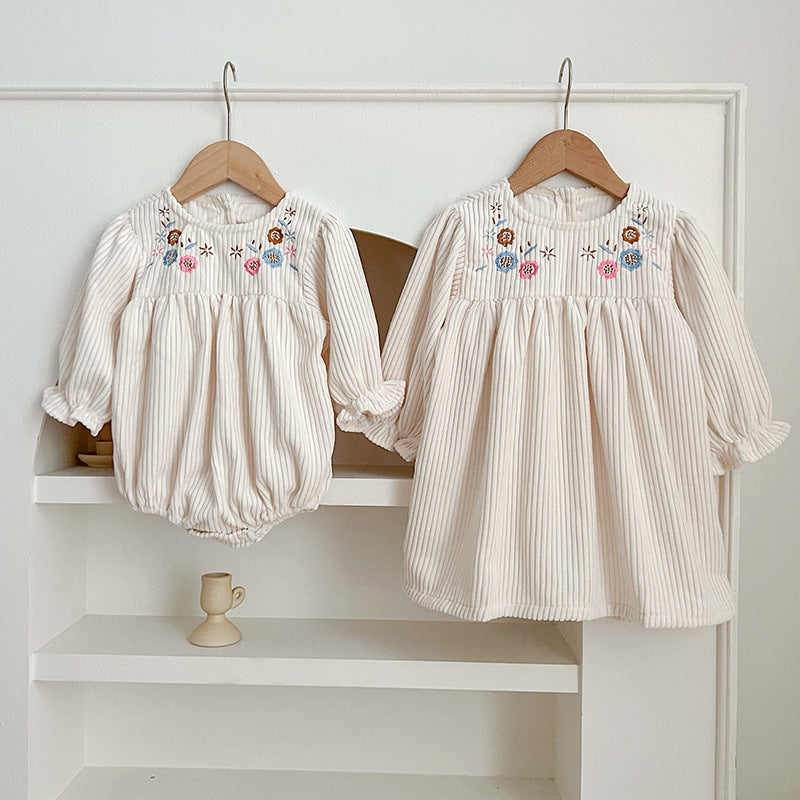 Floral embroidered baby dress in soft white cotton with long sleeves for little girls.