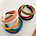 Set of nine solid color cloth headbands for babies and girls in various bright shades