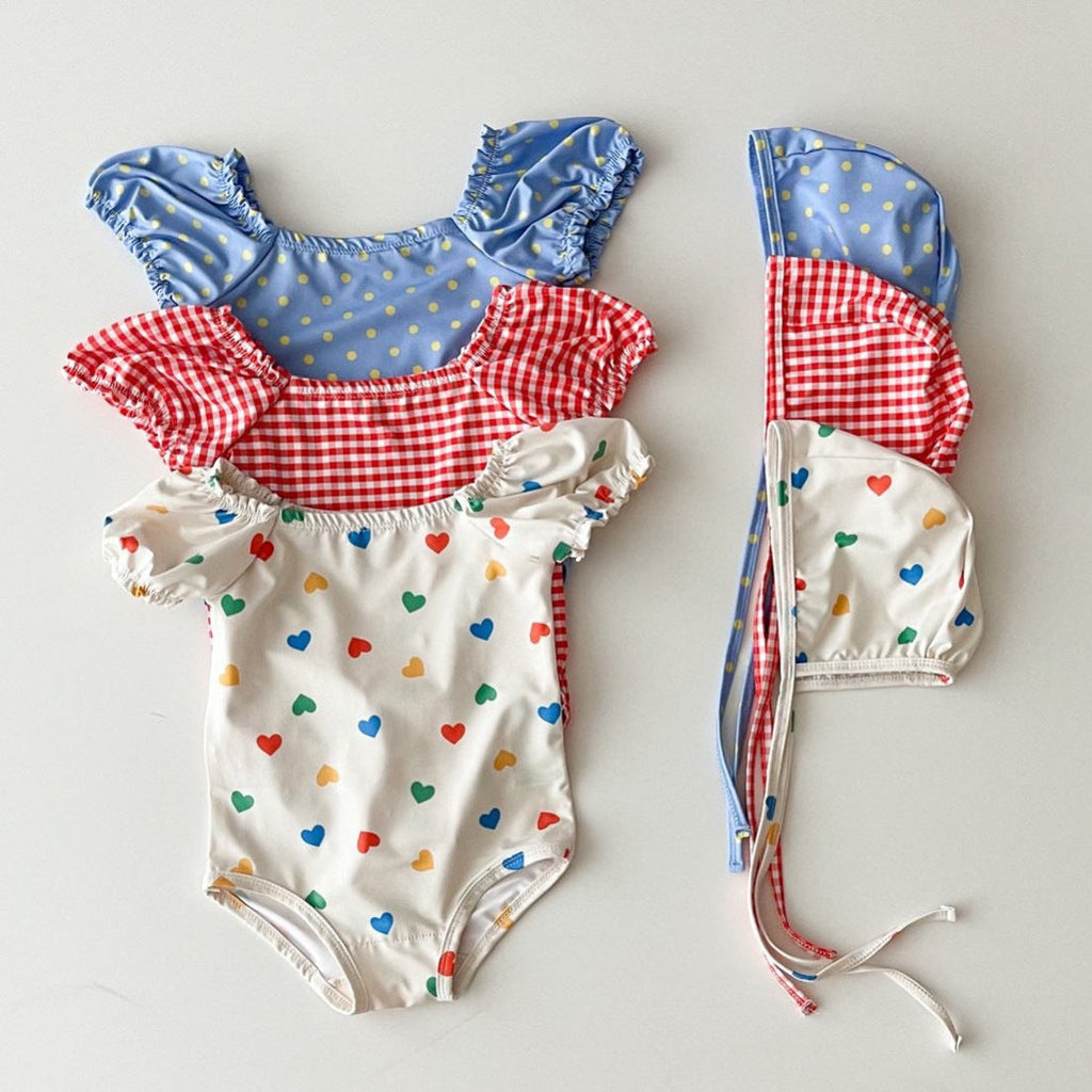 Red and blue plaid polka dot two-piece baby girl swimsuit with matching sun protection hat — view 4