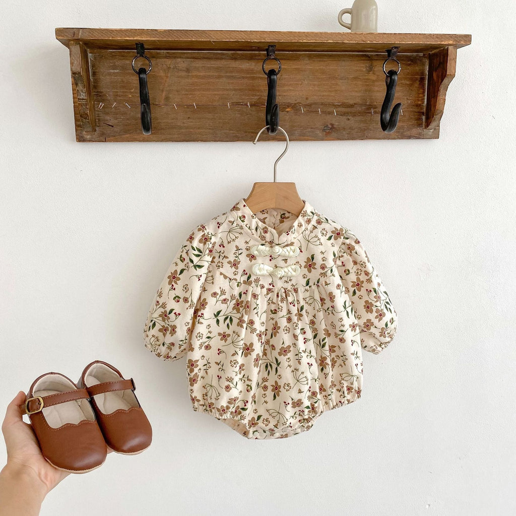 Brown long-sleeve cotton baby bodysuit with vibrant autumn floral pattern and traditional Chinese style details.
