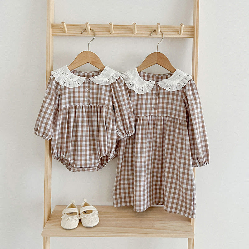 Plaid doll neck baby bodysuit in brown and white cotton with cozy long sleeves.