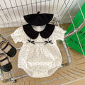 Baby girl polka dot bodysuit in soft white summer cotton with a stylish doll neck