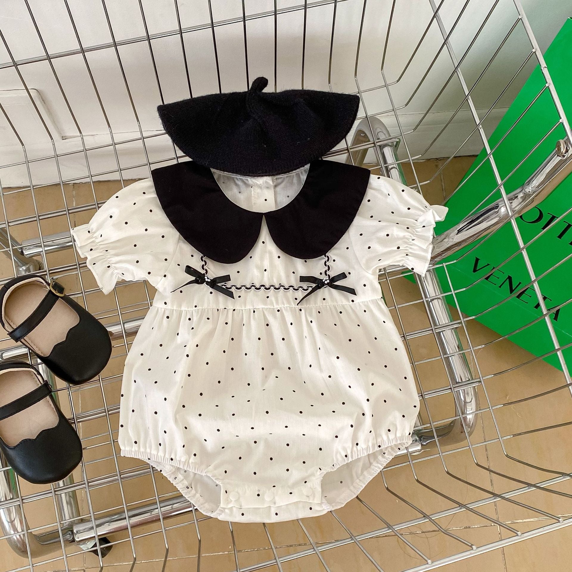 Baby girl polka dot bodysuit in soft white summer cotton with a stylish doll neck