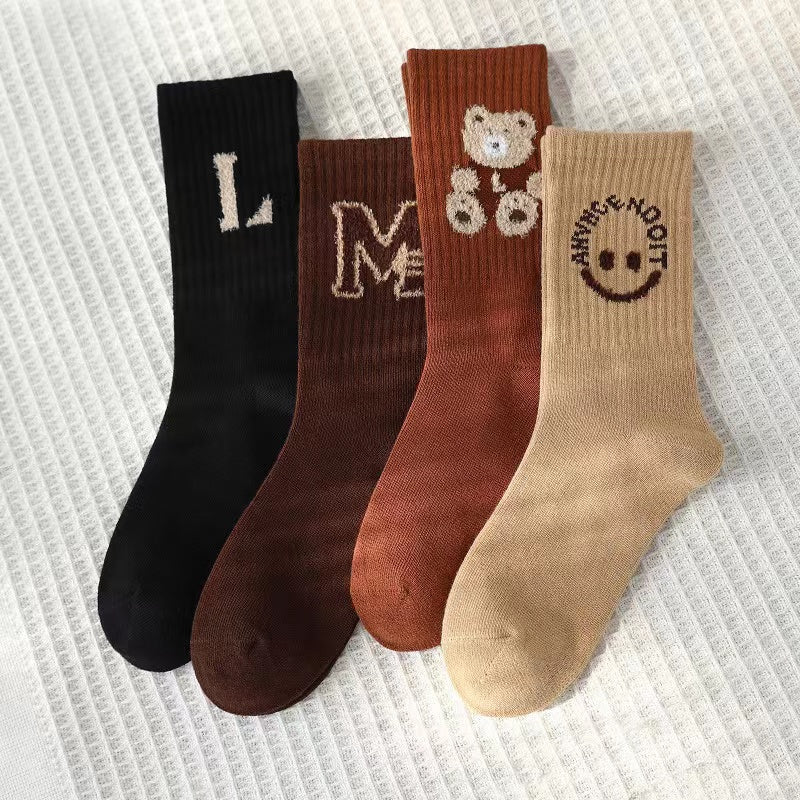 Four pairs of kids soft cotton mid-tube socks in black, apricot, brown, and coffee cartoon patterns — view 2