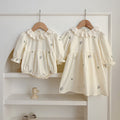 Floral sister matching outfit set with green and beige baby bodysuit and girl's dress