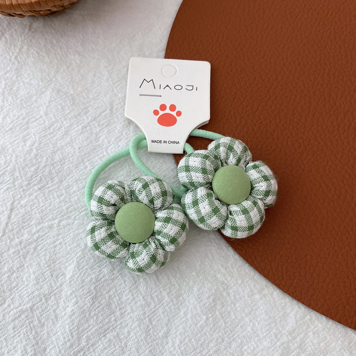 Girls fabric checkered hair elastics with 3D flower accents in pink blue green and yellow — view 2