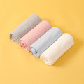 Newborn cotton wrap quilt in solid color, soft baby blanket neatly folded for cozy nursery.
