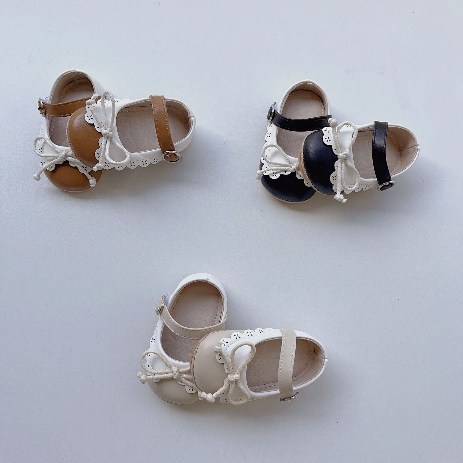 Toddler girl soft sole walking shoes in white with shoelace bow and anti-slip grip — view 2