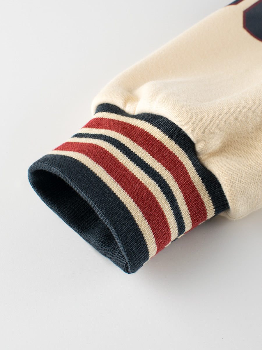 Blue unisex kids baseball jacket with teddy bear print, letter patches, and striped cuffs. — view 4