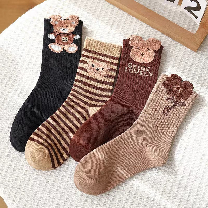 Four pairs of kids soft cotton mid-tube socks in black, apricot, brown, and coffee cartoon patterns — view 3