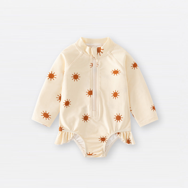 Baby girls zip-up swimwear in earthy floral and polka dot patterns with front zipper detail