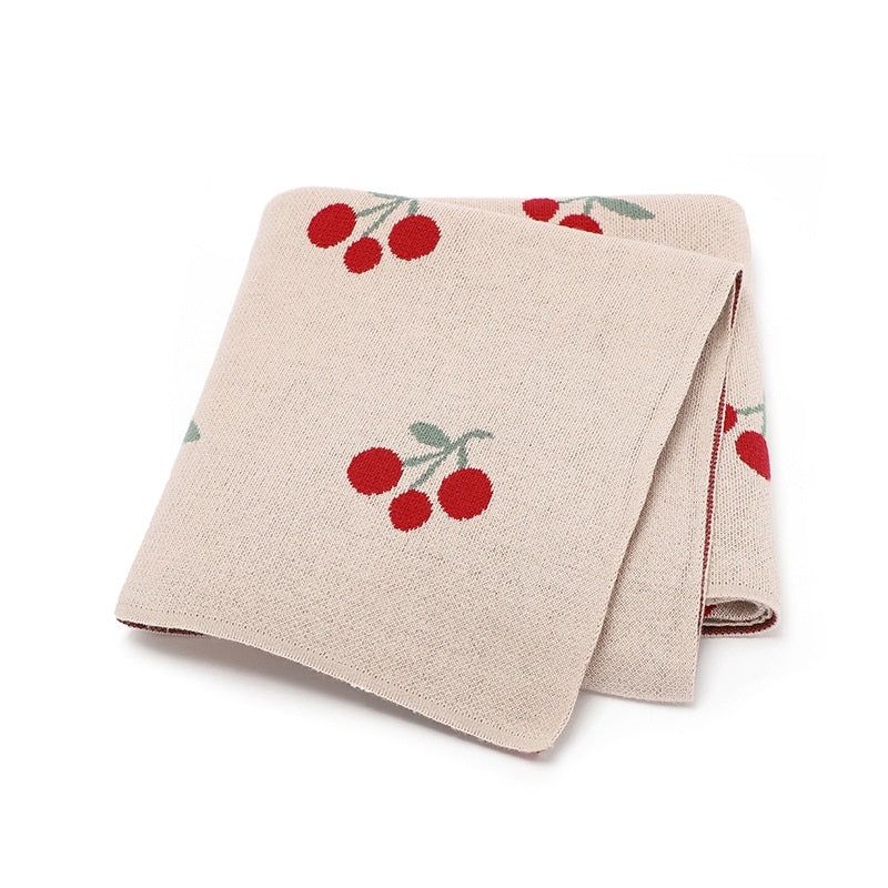 Knitted cherry baby blanket in soft breathable cotton folded neatly for newborn nursery essentials — view 2