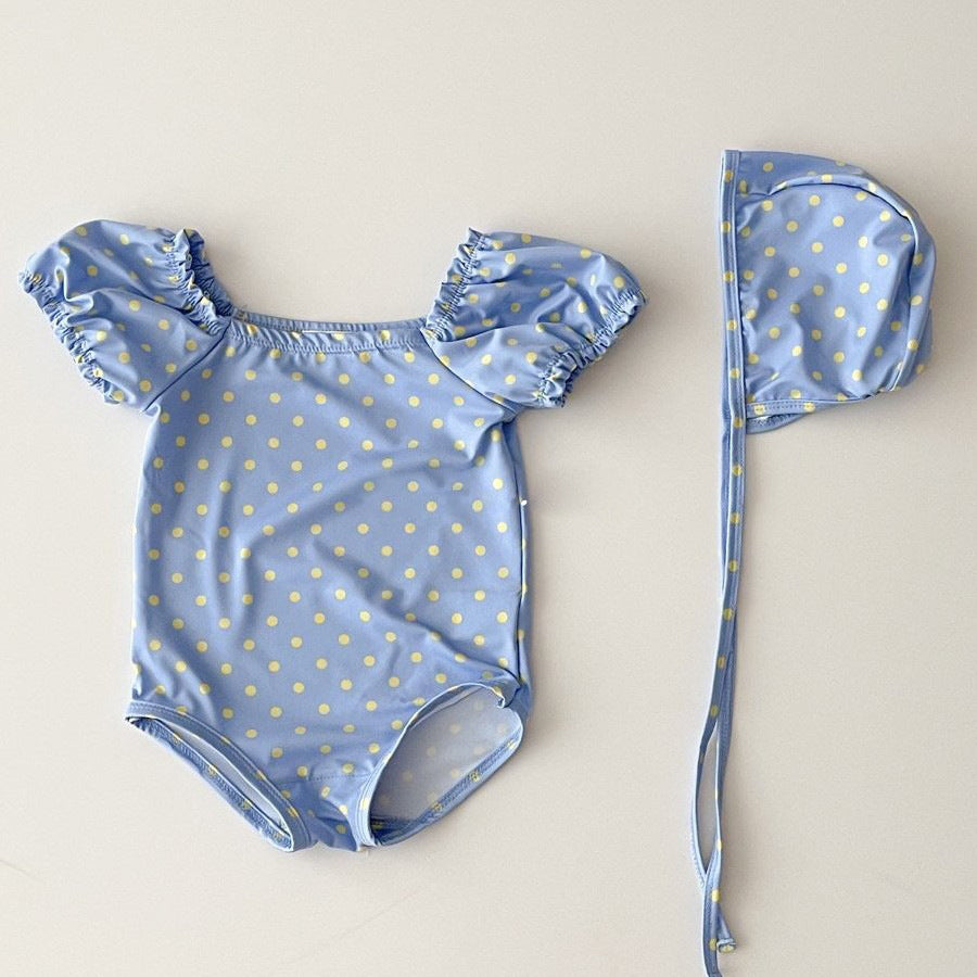 Red and blue plaid polka dot two-piece baby girl swimsuit with matching sun protection hat — view 2