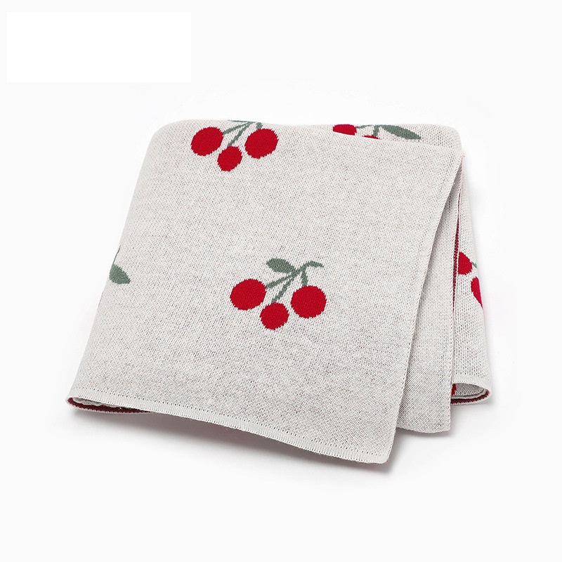 Knitted cherry baby blanket in soft breathable cotton folded neatly for newborn nursery essentials — view 3