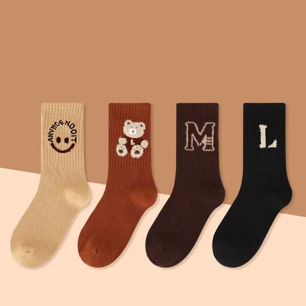 Four pairs of kids soft cotton mid-tube socks in black, apricot, brown, and coffee cartoon patterns — view 5