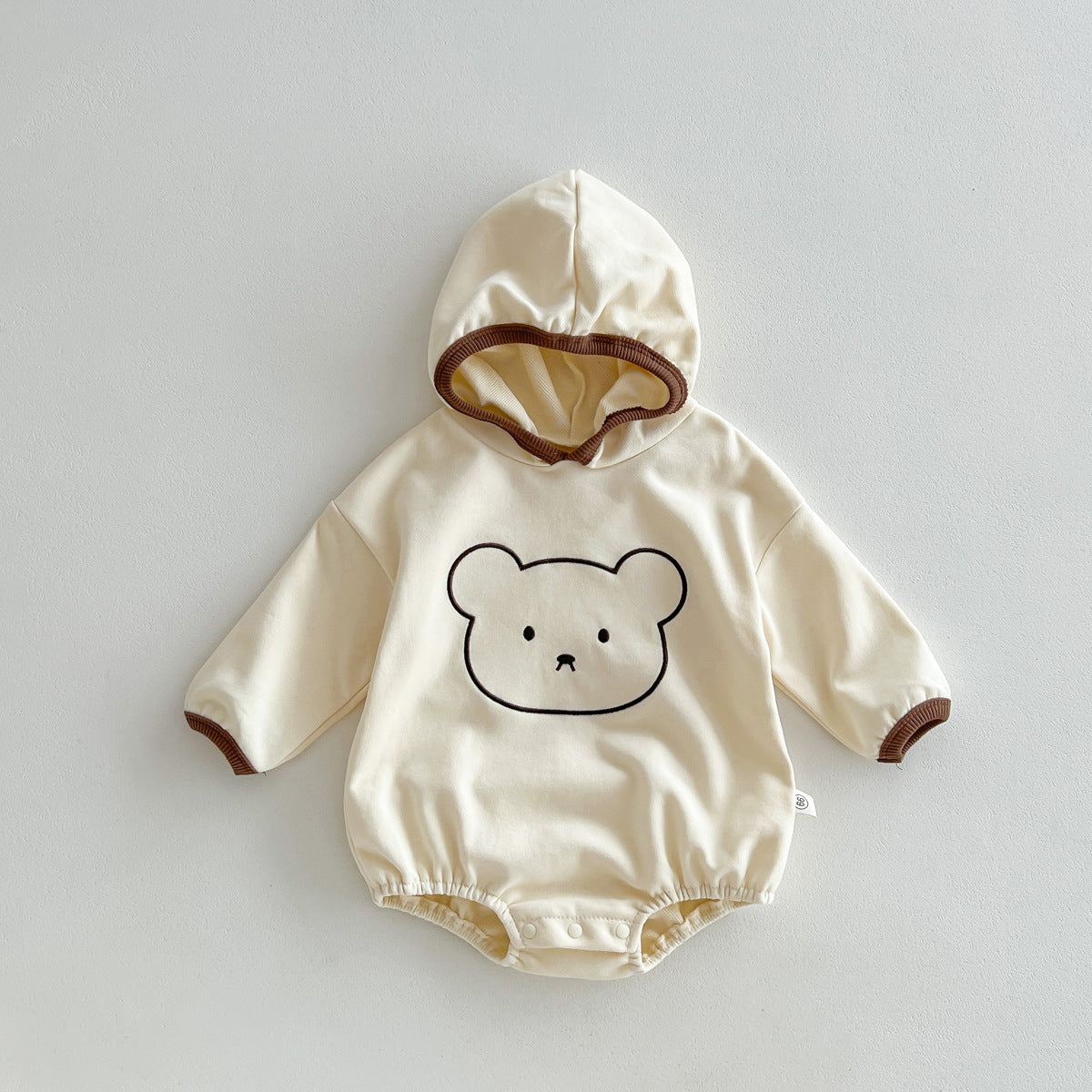 Unisex baby hooded bodysuit in beige cotton with a cute teddy bear pattern — view 2