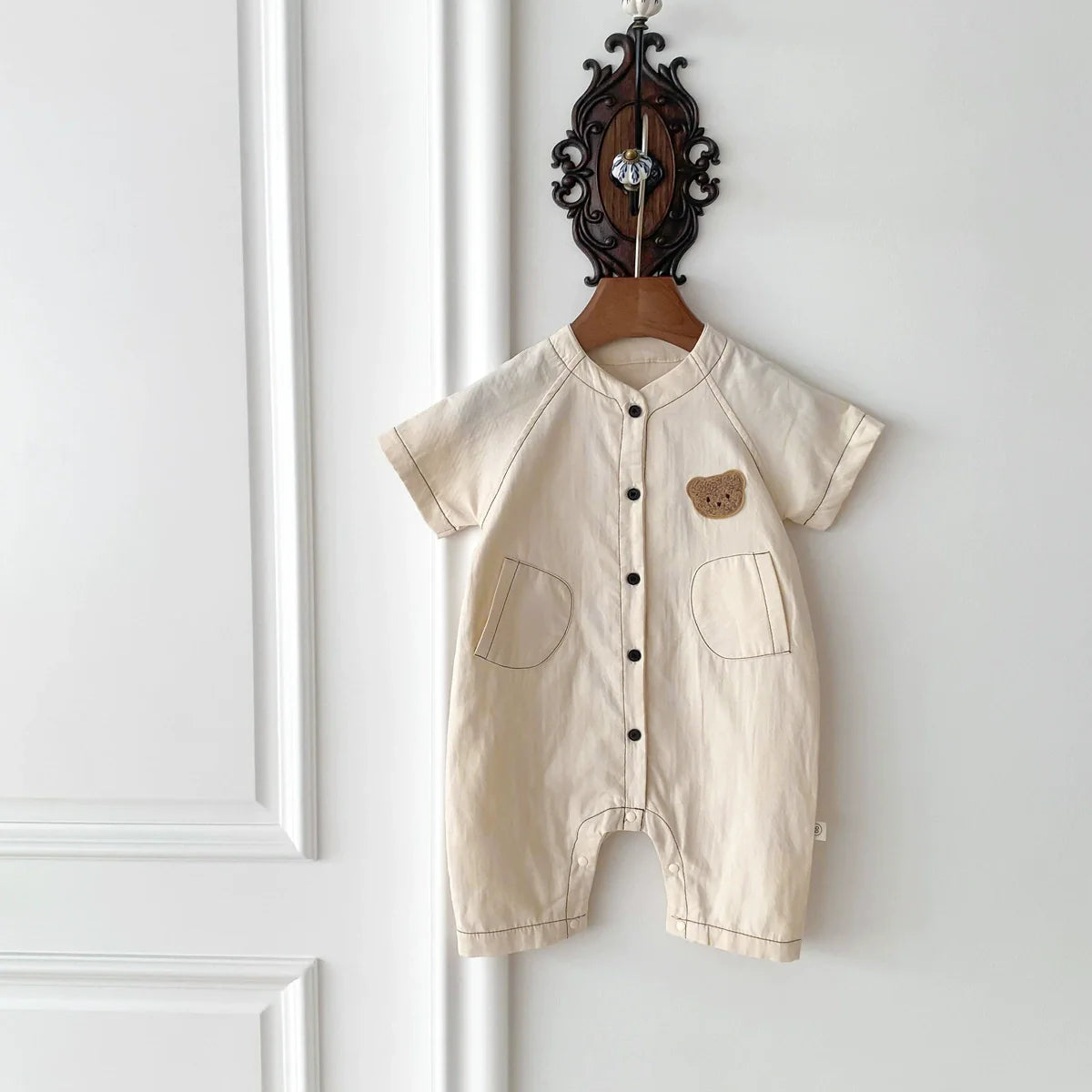 Short sleeve unisex baby teddy bear romper in soft cotton with a single breasted front closure — view 2