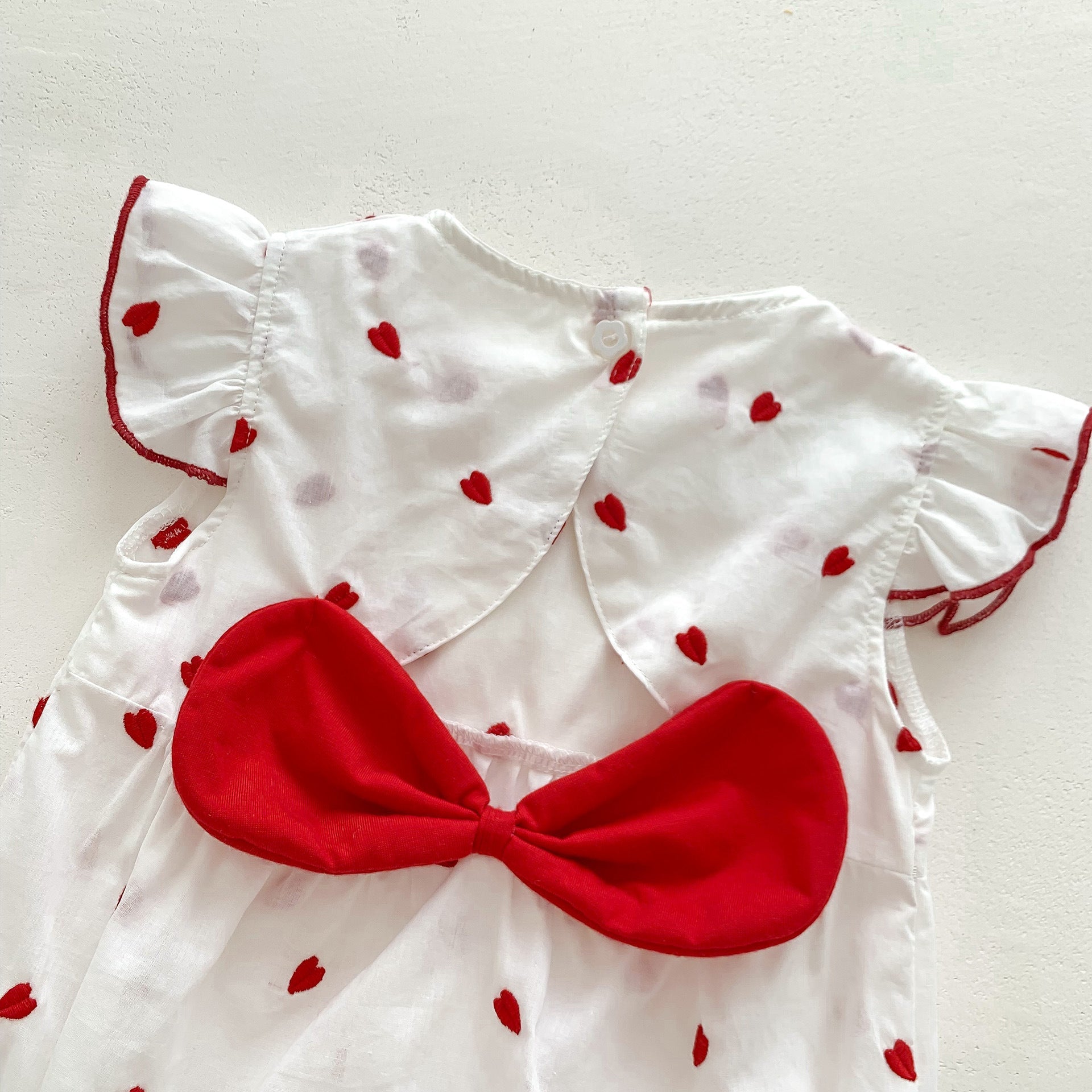 Baby girls beige summer bodysuit featuring a red heart print and delicate flutter fly sleeves. — view 5