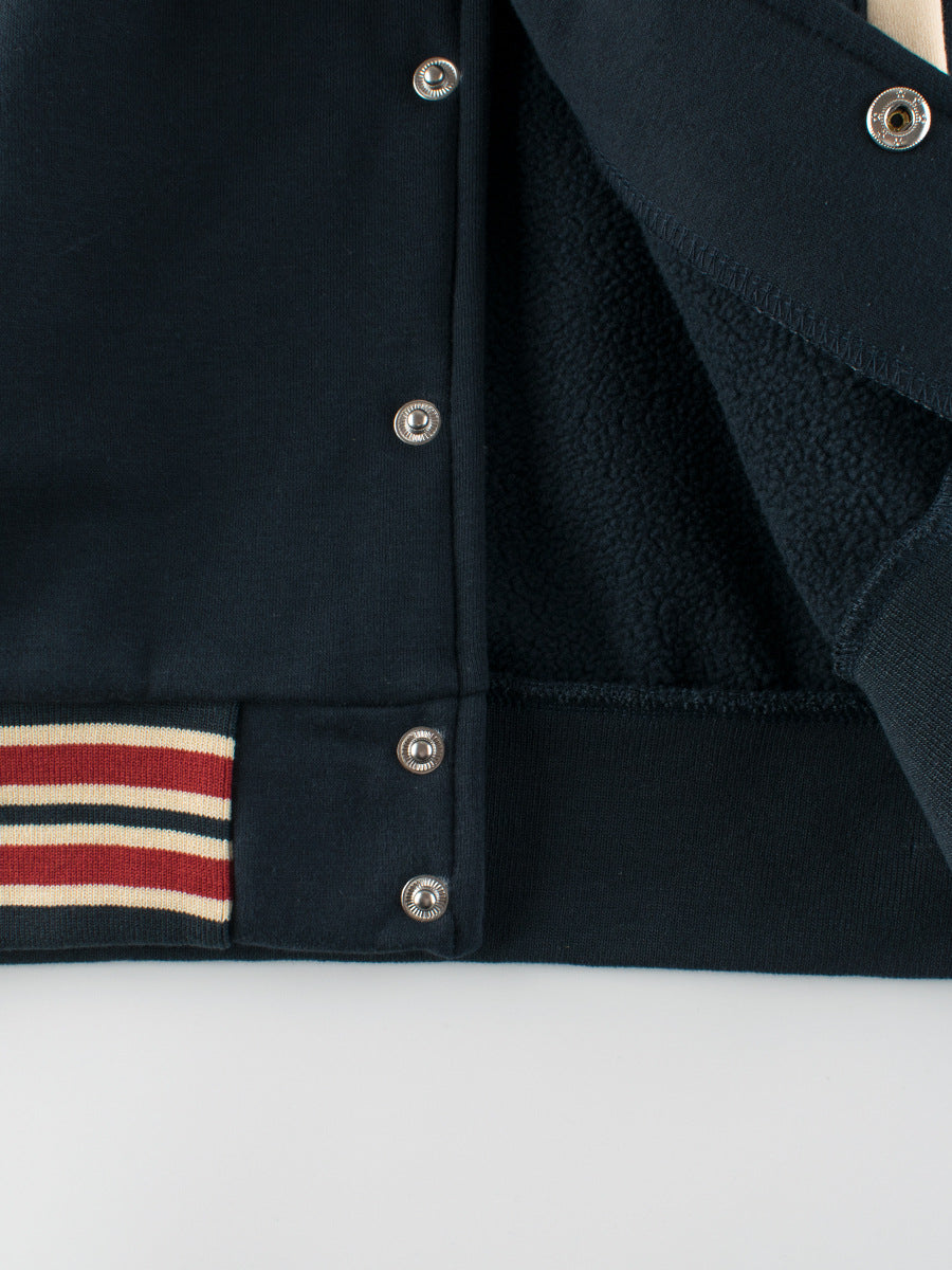 Blue unisex kids baseball jacket with teddy bear print, letter patches, and striped cuffs. — view 5