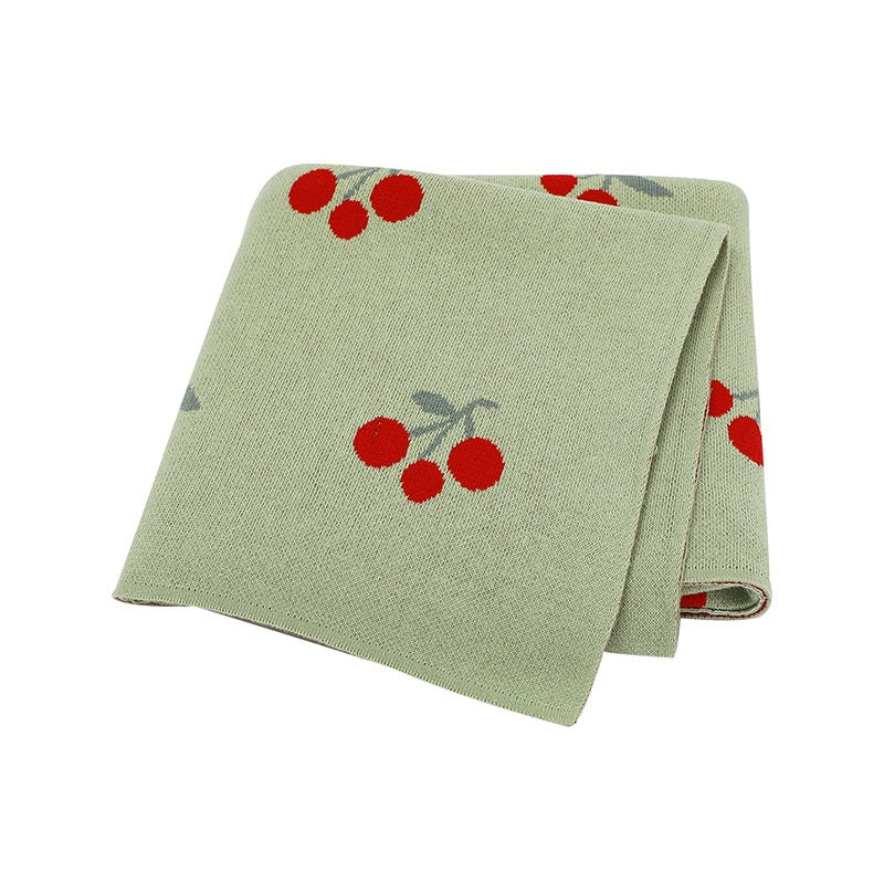 Knitted cherry baby blanket in soft breathable cotton folded neatly for newborn nursery essentials — view 4