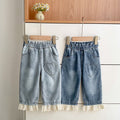 Girls lace patchwork denim pants with heart pattern and color-blocking in light blue cotton blend.