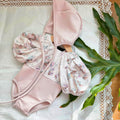 Baby girl pink floral swimwear set with puff sleeves and matching sun protection hat