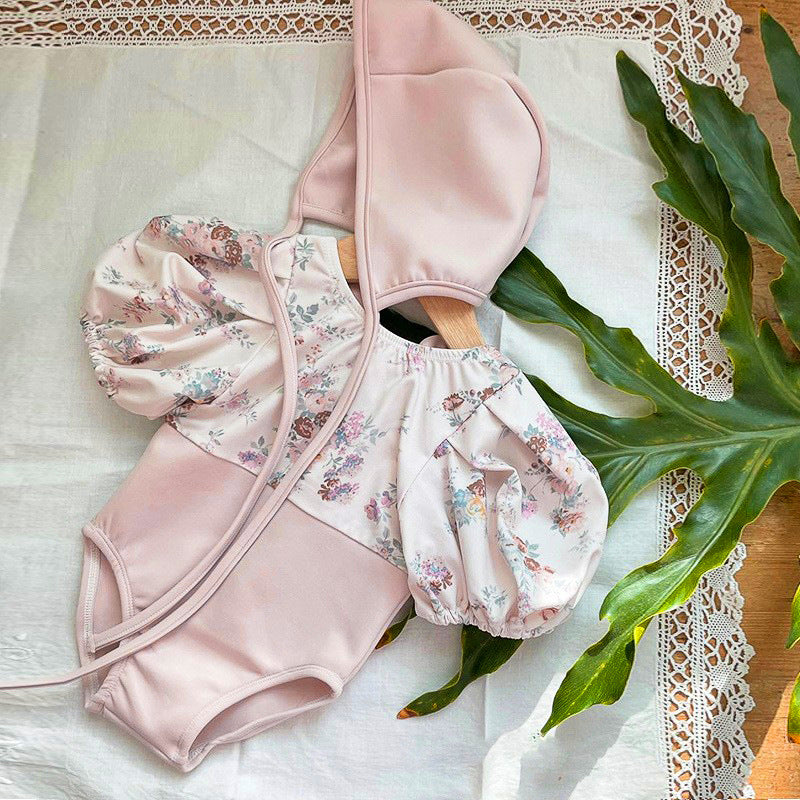 Baby girl pink floral swimwear set with puff sleeves and matching sun protection hat