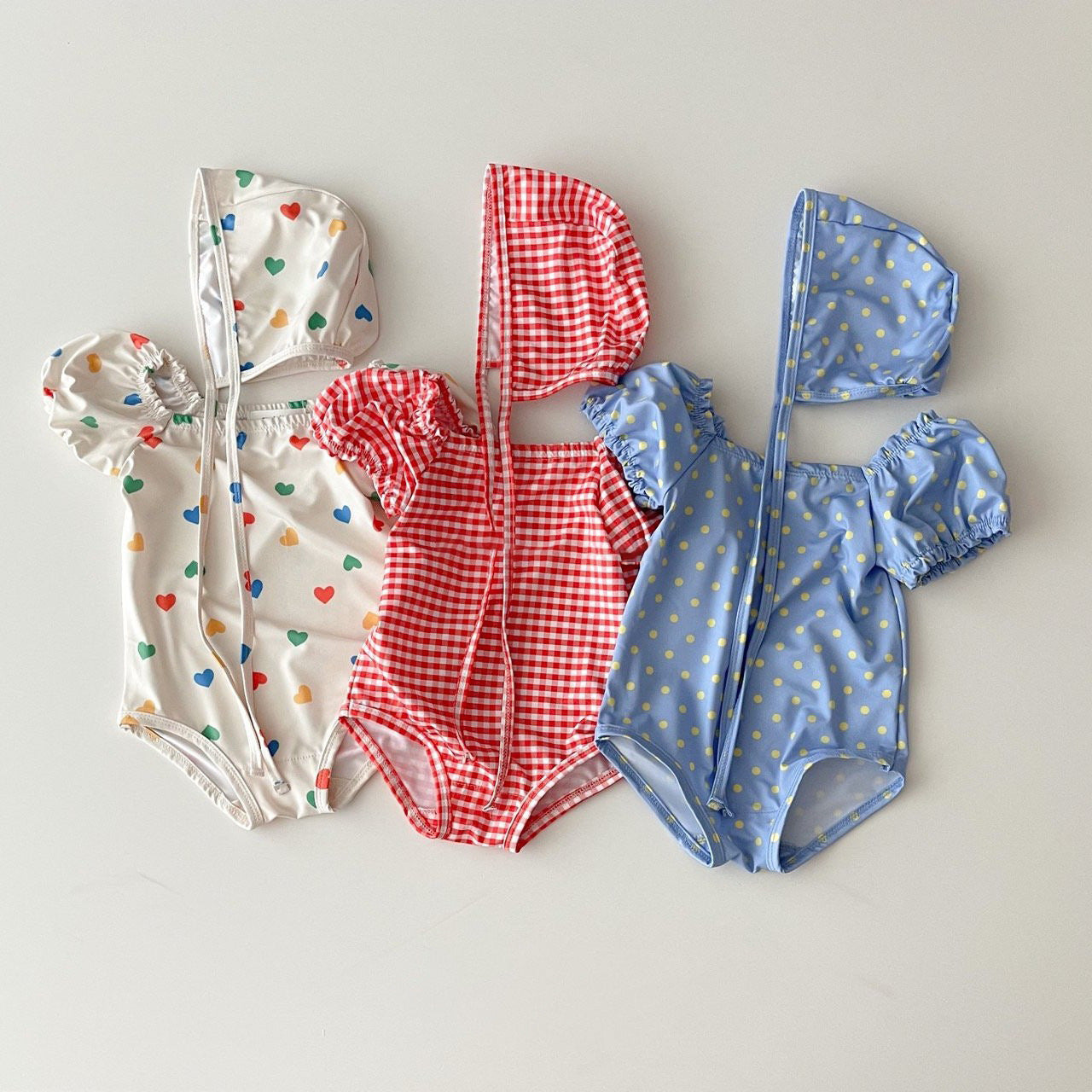 Red and blue plaid polka dot two-piece baby girl swimsuit with matching sun protection hat