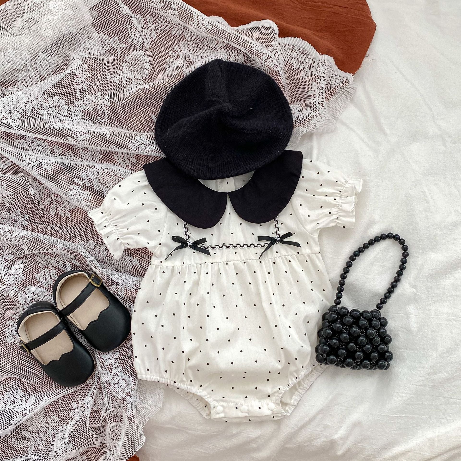 Baby girl polka dot bodysuit in soft white summer cotton with a stylish doll neck — view 2