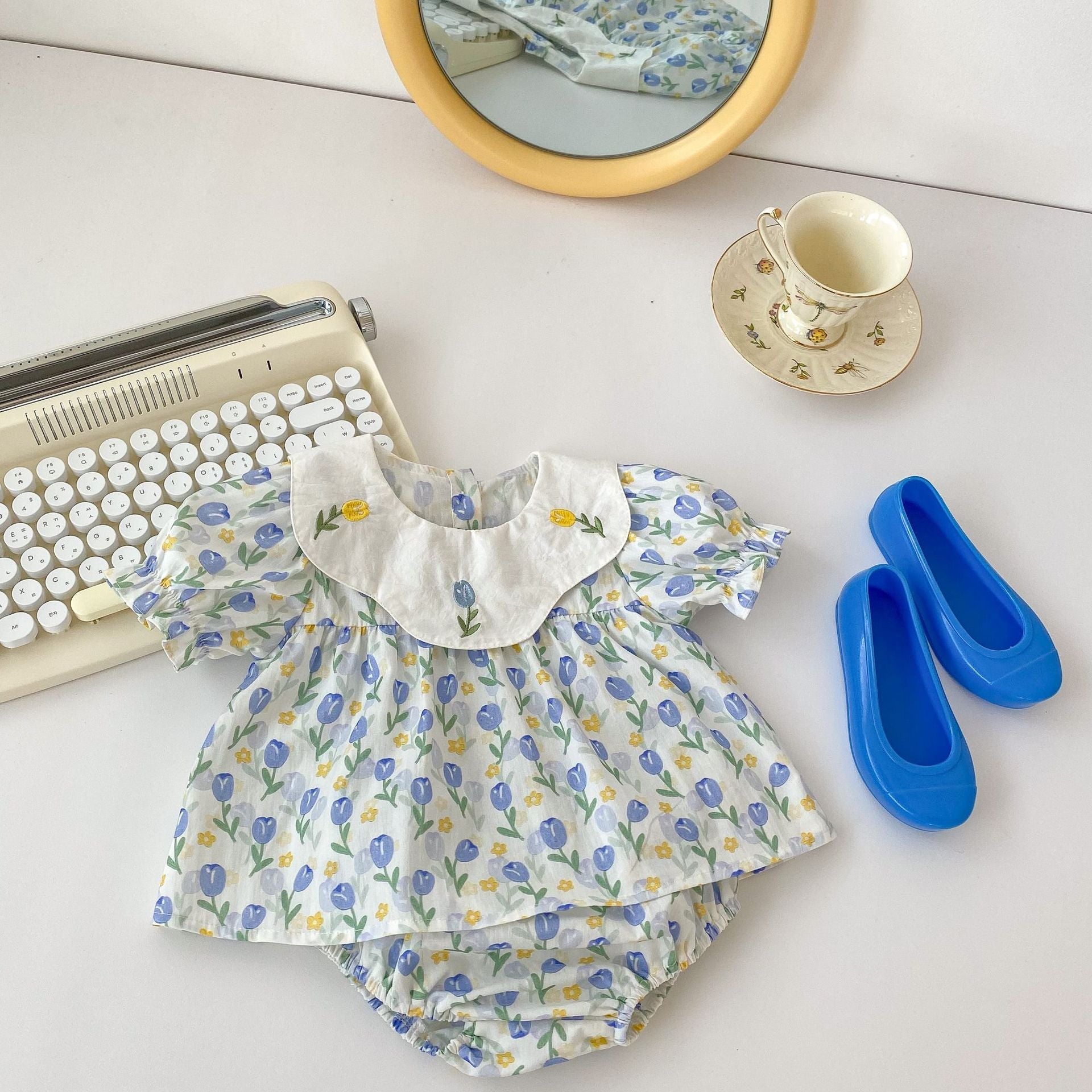 Blue cotton baby clothing set with floral embroidered doll neck top and matching shorts