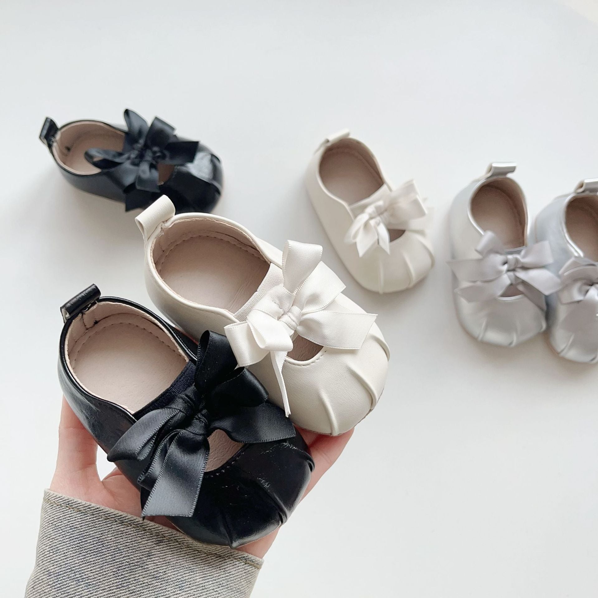 Baby girl polyurethane walking shoes featuring a butterfly bow pattern and anti slip bottom grips