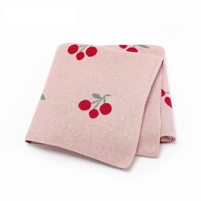 Knitted cherry baby blanket in soft breathable cotton folded neatly for newborn nursery essentials — view 5