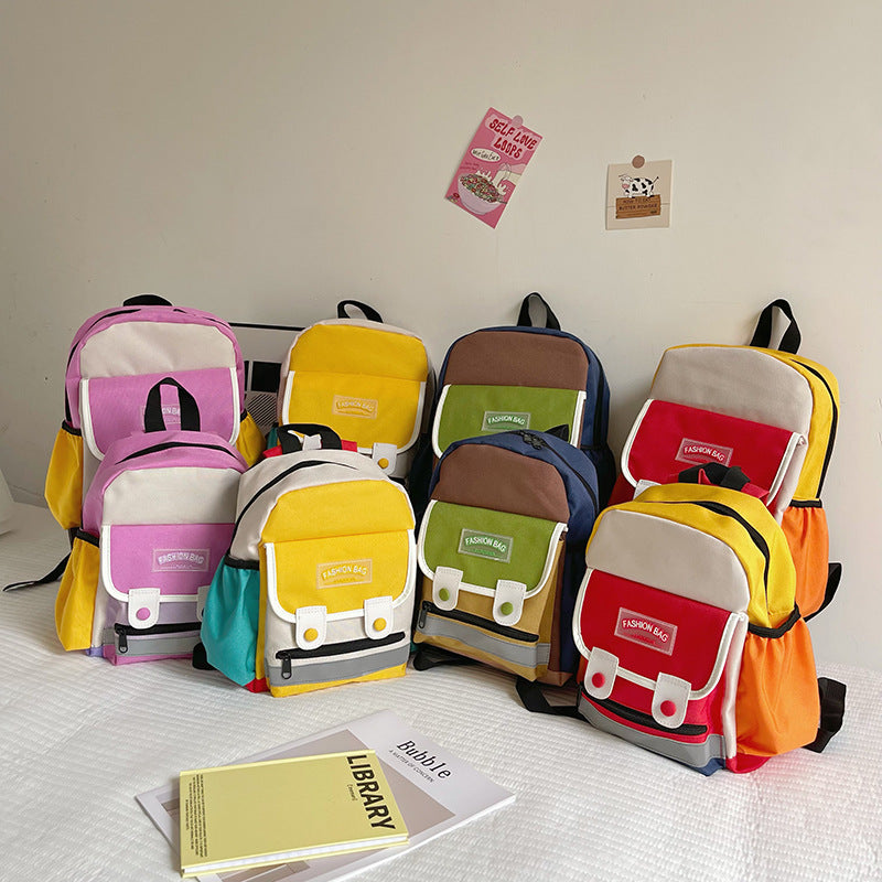Preschool canvas backpack for children featuring a colorful patchwork design and spacious main storage compartment