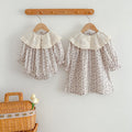 Floral matching sister dress set with light blue baby bodysuit and embroidered girl dress.