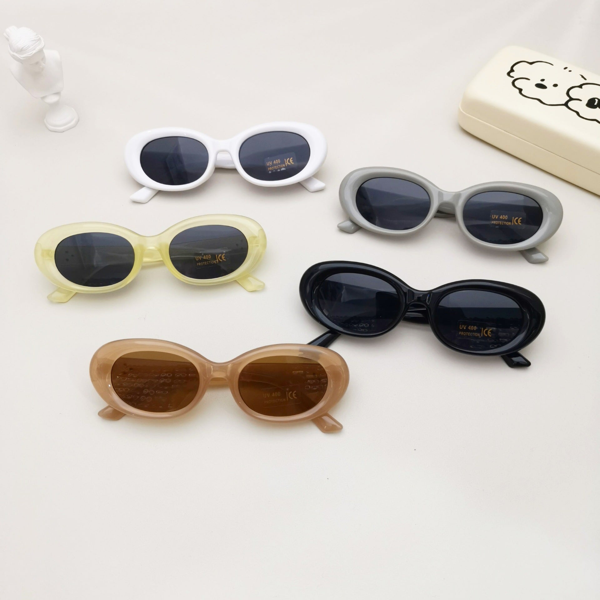 Kids oval beach sunglasses in solid colors featuring lightweight polycarbonate frames and UV protective lenses